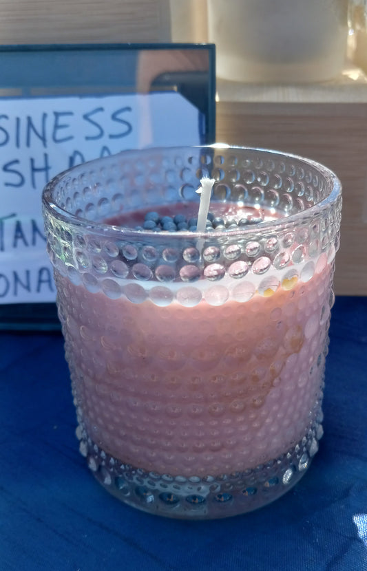 A Soy Wax Candle fragranced with rose and berry essential oils for longer lasting fragrance. The glass beaded containers are repurposed glass from thrift stores and the decorated silver beads on top are sugar cake decorations. Environmentally sustainable is the vision of Tanya Lee Raycroft LLC